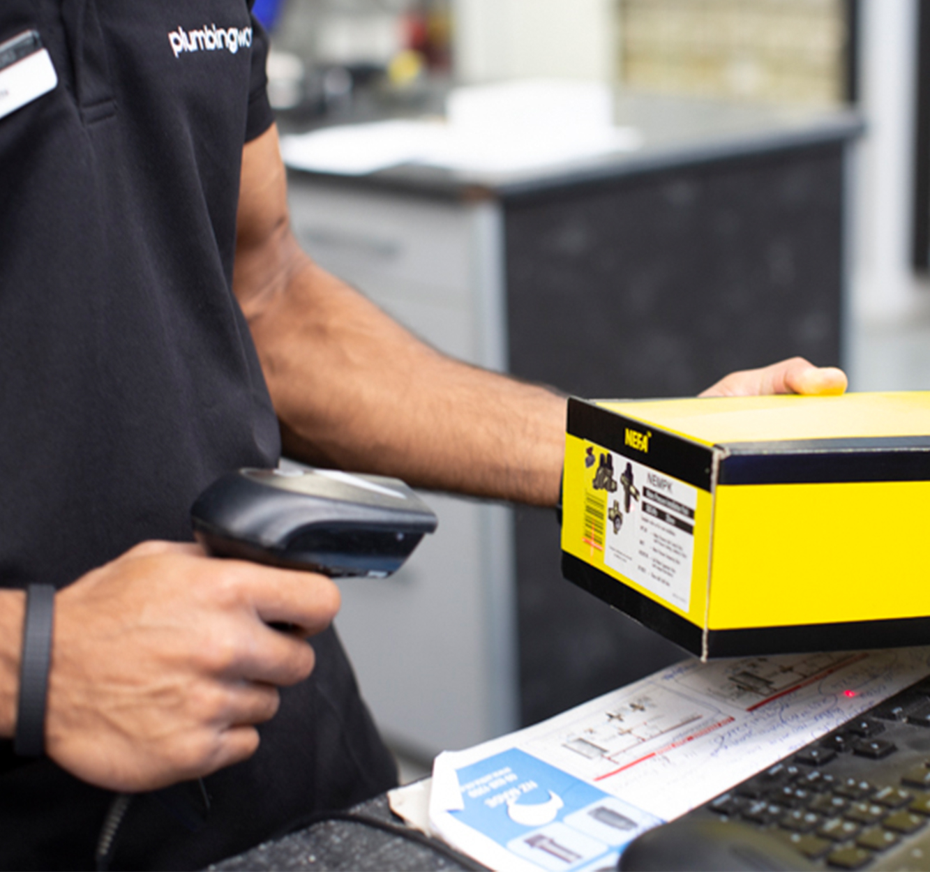 Plumbing World Careers | Staff scanning products for customer